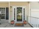 Charming front entrance featuring a decorative wreath, sidelights, and a 'Home Sweet Home' welcome mat at 1127 Woodlands Creek Way, Apex, NC 27502
