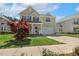 Charming two-story home boasts a manicured lawn, mature tree, and inviting front porch at 1127 Woodlands Creek Way, Apex, NC 27502