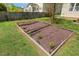 Backyard garden bed, ready for planting and adding natural beauty to the property at 1127 Woodlands Creek Way, Apex, NC 27502