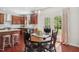 Kitchen and dining area with granite countertops, wood cabinets, and a sliding glass door to the backyard at 1127 Woodlands Creek Way, Apex, NC 27502