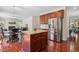 Open kitchen featuring an island, stainless steel appliances, and granite countertops adjacent to the dining area at 1127 Woodlands Creek Way, Apex, NC 27502