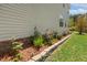 Landscaped yard featuring lush green lawn and decorative stone border at 1127 Woodlands Creek Way, Apex, NC 27502