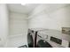 Well-lit laundry room features shelving units and modern appliances at 1127 Woodlands Creek Way, Apex, NC 27502