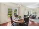 Bright dining area with sliding doors leading to the patio and comfortable seating area at 1127 Woodlands Creek Way, Apex, NC 27502