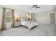 Spacious main bedroom featuring tray ceilings, soft carpet, and bright windows dressed in stylish draperies at 1127 Woodlands Creek Way, Apex, NC 27502