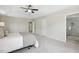 Spacious main bedroom with soft carpet, stylish decor, tray ceiling, and access to the bathroom at 1127 Woodlands Creek Way, Apex, NC 27502