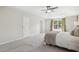 Spacious main bedroom featuring tray ceilings, soft carpet, and bright windows dressed in stylish draperies at 1127 Woodlands Creek Way, Apex, NC 27502