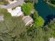 Aerial view of homes located on a lake, surrounded by mature trees and neighborhoods at 113 Weatherhill Pt, Carrboro, NC 27510