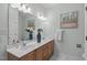 Bright bathroom featuring double sinks, a large mirror, and modern fixtures at 113 Weatherhill Pt, Carrboro, NC 27510