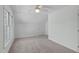 Bright bedroom features natural light from a window, plush carpet, and light walls at 113 Weatherhill Pt, Carrboro, NC 27510