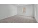 This bedroom has a big window and neutral-colored carpet at 113 Weatherhill Pt, Carrboro, NC 27510