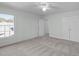 This empty bedroom is bright with a ceiling fan and closet at 113 Weatherhill Pt, Carrboro, NC 27510