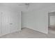 Neutral bedroom features a ceiling fan, light walls, plush carpet and double door closet at 113 Weatherhill Pt, Carrboro, NC 27510