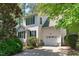 Charming two-story home with white siding, black shutters and attached one car garage at 113 Weatherhill Pt, Carrboro, NC 27510