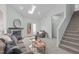 Bright living room featuring a fireplace, skylight, and staircase at 113 Weatherhill Pt, Carrboro, NC 27510