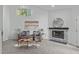 Cozy living room boasts a stone fireplace and a half-moon window at 113 Weatherhill Pt, Carrboro, NC 27510