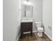 Well-lit half bathroom featuring a modern vanity, mirror, and fixtures at 1217 Neighborly Way, Morrisville, NC 27560