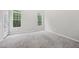 Light-filled bedroom with neutral carpet and ample natural light from dual windows at 1217 Neighborly Way, Morrisville, NC 27560
