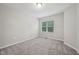 Bedroom with neutral carpet and a window with wooded view at 1217 Neighborly Way, Morrisville, NC 27560