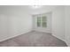Bright bedroom with soft carpet and a window view, offering a cozy and inviting space at 1217 Neighborly Way, Morrisville, NC 27560
