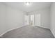 Spacious bedroom with neutral carpet and multiple entry doors at 1217 Neighborly Way, Morrisville, NC 27560