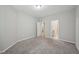 Comfortable bedroom with plush carpet, showcasing access to the bathroom and kitchen at 1217 Neighborly Way, Morrisville, NC 27560
