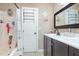 Bathroom featuring a double vanity with a black cabinet, a shower-tub combo, and ample storage at 13 Thorne Ridge Dr, Durham, NC 27713