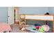 Bedroom with a wooden bunk bed and view to the hall with partially visible pink bed at 13 Thorne Ridge Dr, Durham, NC 27713