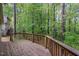 Wooden deck overlooking a lush, green wooded area, offering a peaceful outdoor retreat at 13 Thorne Ridge Dr, Durham, NC 27713
