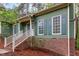 Charming home with green siding, brick accents, and a welcoming front porch, offering cozy curb appeal at 13 Thorne Ridge Dr, Durham, NC 27713