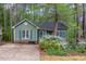 Charming home exterior with lush landscaping, a driveway, and green siding, creating curb appeal at 13 Thorne Ridge Dr, Durham, NC 27713