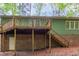 Exterior of home features a wooden deck with stairs leading down to a door at ground level at 13 Thorne Ridge Dr, Durham, NC 27713
