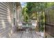 Back deck with seating, dining table, and view of the landscaped yard at 1322 Pebble Creek Xing, Durham, NC 27713