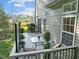 Back deck with dining set and views of the grassy yard and surrounding homes at 1322 Pebble Creek Xing, Durham, NC 27713