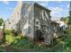 Rear view of home featuring light siding, many windows, a wooden deck with stairs and a landscaped yard at 1322 Pebble Creek Xing, Durham, NC 27713