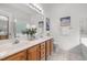 Double sink bathroom with neutral decor and plenty of natural light at 1322 Pebble Creek Xing, Durham, NC 27713