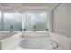 Bright view of a tiled bathtub and a shower with glass door at 1322 Pebble Creek Xing, Durham, NC 27713