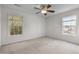 Spacious carpeted bedroom with a ceiling fan and two windows, bringing in lots of natural light at 1322 Pebble Creek Xing, Durham, NC 27713