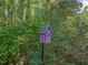 Close up of a pink painted birdhouse with greenery background at 1322 Pebble Creek Xing, Durham, NC 27713