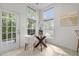 Bright breakfast nook with glass table and chairs, lit by many windows at 1322 Pebble Creek Xing, Durham, NC 27713