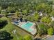 Aerial view of a neighborhood pool surrounded by trees and green spaces at 1322 Pebble Creek Xing, Durham, NC 27713