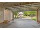 View from the garage of the home across the street, with an open garage door and concrete floor at 1322 Pebble Creek Xing, Durham, NC 27713