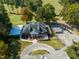 Aerial view of golf course clubhouse with golf cart parking and surrounding trees at 140 Clear Water Rd, Louisburg, NC 27549