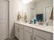 Bathroom features double sink vanity with white cabinets, quartz countertop, and brushed nickel hardware at 140 Clear Water Rd, Louisburg, NC 27549