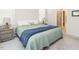 Bright bedroom with carpet, two windows, two nightstands and view to the bathroom with standing shower at 140 Clear Water Rd, Louisburg, NC 27549