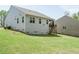 Exterior view of the home features a grassy backyard and screened in porch at 140 Clear Water Rd, Louisburg, NC 27549