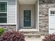 Inviting front entrance with stone accents, and a tiled front porch for a warm welcome at 140 Clear Water Rd, Louisburg, NC 27549