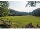 Scenic golf course view with bunkers and lush trees enhancing the natural beauty of the landscape at 140 Clear Water Rd, Louisburg, NC 27549
