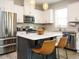 Bright kitchen features white cabinets, stainless steel appliances, and a central island with seating at 140 Clear Water Rd, Louisburg, NC 27549