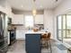 Bright kitchen with a center island, stainless steel appliances, and a sliding glass door to the deck at 140 Clear Water Rd, Louisburg, NC 27549